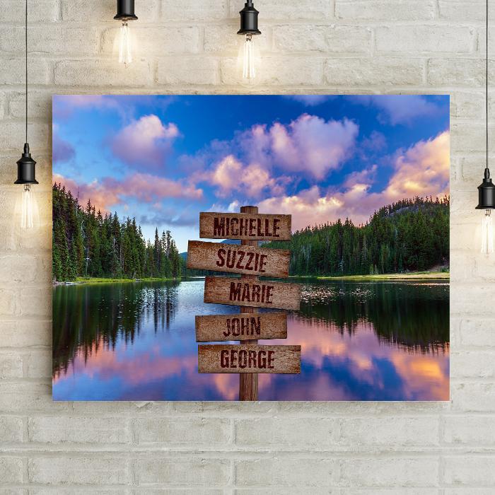 Gorgeous Mountain Landscape Wall Art for Cabin or Lake House in Mountains. Pine Forest with lake reflecting dramatic Rocky Mountain Sky. Canvas Print Wall Artwork is beautiful decor for family room or bedroom artwork. Personalized with custom carved wood crossroads navigation sign. Lemonsareblue Lemons Are Blue Brand