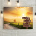 Road less traveled country road artwork. Canvas print wall decor with country morning sunrise and misty farm fields at dawn. Backroads farmhouse wall decor with carved wood road sign at crossroads with custom names or text.