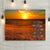 Dramatic sunset in the countryside overlooking rolling hills with sunkissed wheat fields and a dramatic sky. This gallery wrapped 1 1/2 deep canvas wall hanging artwork includes personalized carved wood crossroads direction signs with up to 12 names on individual wood planks nailed to a wooden post.