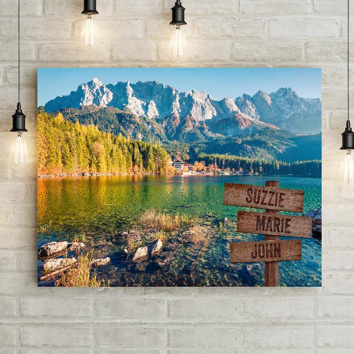 Rocky  Mountain lake Canvas Living Room Art Print features autumn leaves in a pine tree forest on a clear blue lake. Personalized with your names or dates on a carved wood crossroads sign.