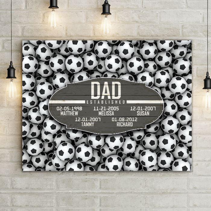 Soccer Dad Established Date Canvas Print Wall Hanging.  Beautiful Home Decor, Office Decoration, or Man Cave Sign.  Best Father's Day Gift Idea for #1 Dad. Carved wood Sign for sports enthusiast on a background of sports-themed wall art.